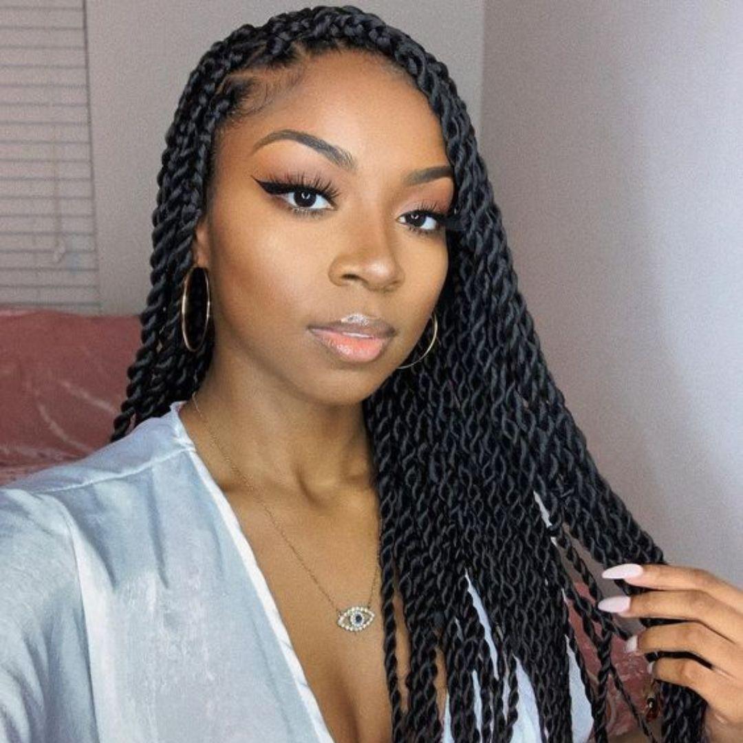 Long black rope twists with a side part, worn past the shoulders